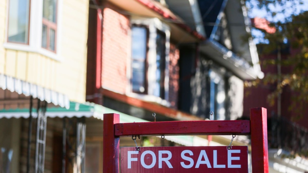 A real estate sign is displayed in front of a house in Toronto on Wednesday, September 29, 2021. THE CANADIAN PRESS/Evan Buhler