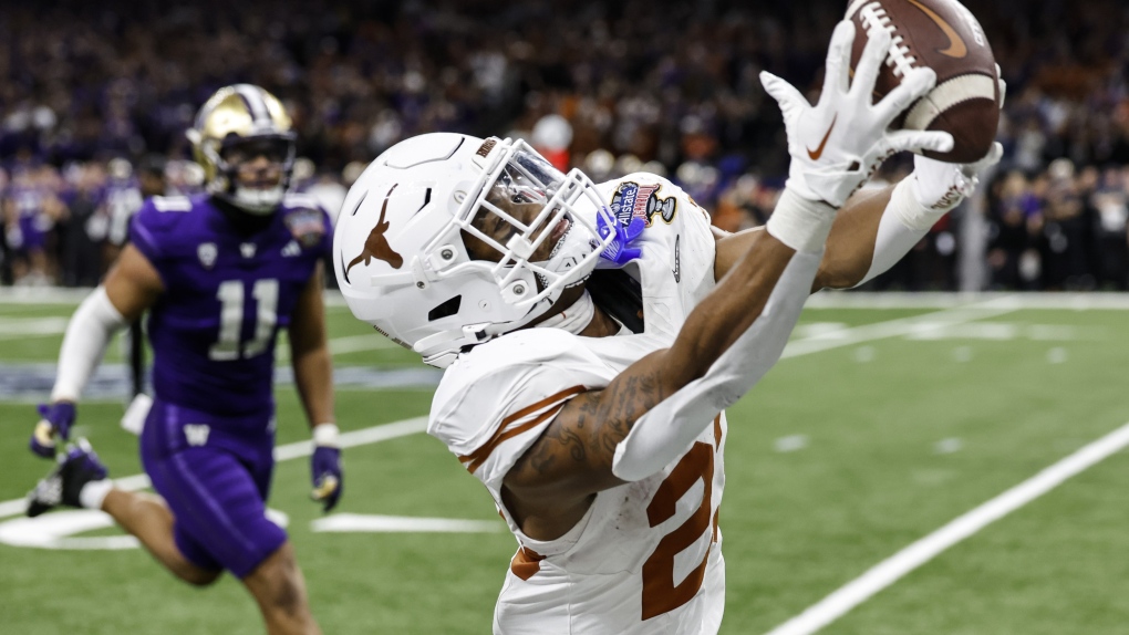 Texas defensive back Jahdae Barron (23) makes the catch against Washington during the second half of the Sugar Bowl CFP NCAA semifinal college football game between Washington and Texas, Monday, Jan. 1, 2024, in New Orleans. Washington won 37-31. (AP Photo/Butch Dill)