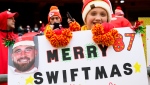 A Kansas City Chiefs fan holds up a sign tying Kansas City Chiefs tight end Travis Kelce and Taylor Swift together during warmups before an NFL football game against the Las Vegas Raiders, Monday, Dec. 25, 2023 in Kansas City, Mo. (AP Photo/Reed Hoffmann)