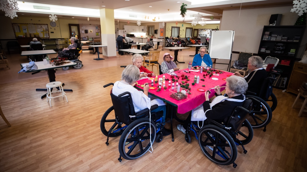 Inglewood Care Centre residents paint pine cones during arts and crafts recreation time at the long-term care home in West Vancouver, on Thursday, December 16, 2021. (THE CANADIAN PRESS/Darryl Dyck)