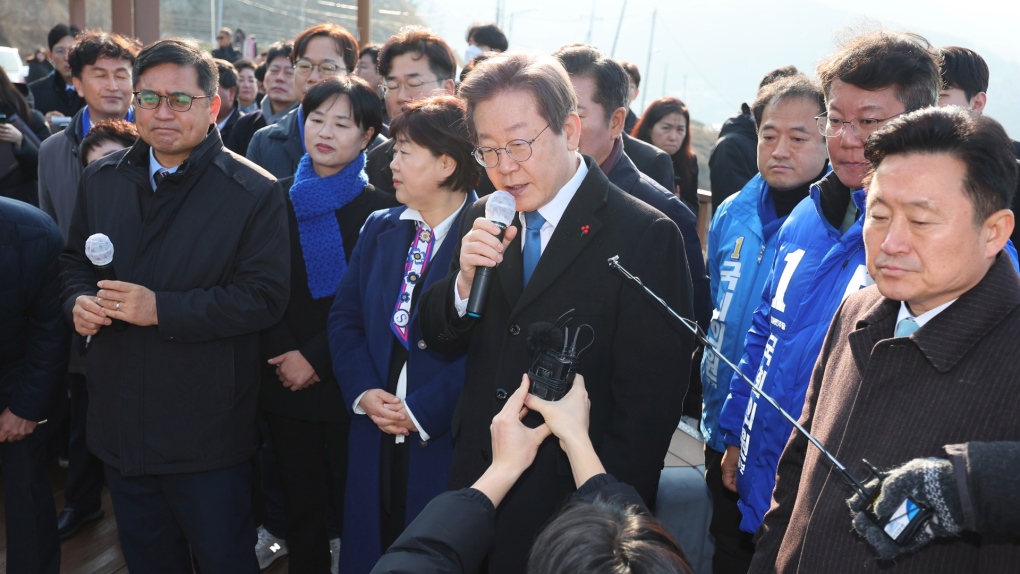 South Korean opposition leader Lee Jae-myung, centre, speaks as he visits the construction site of a new airport in Busan, South Korea, Jan. 2, 2024. (Sohn Hyung-joo/Yonhap via AP)