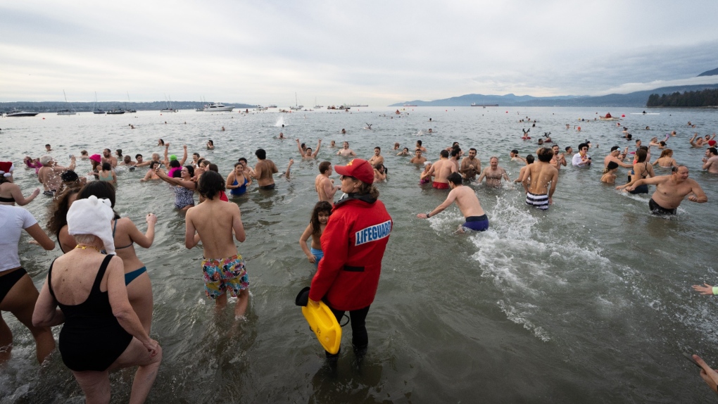People participate in the Polar Bear Swim on New Year’s Day at English Bay Beach in Vancouver, B.C., Jan. 1, 2024. THE CANADIAN PRESS/Ethan Cairns