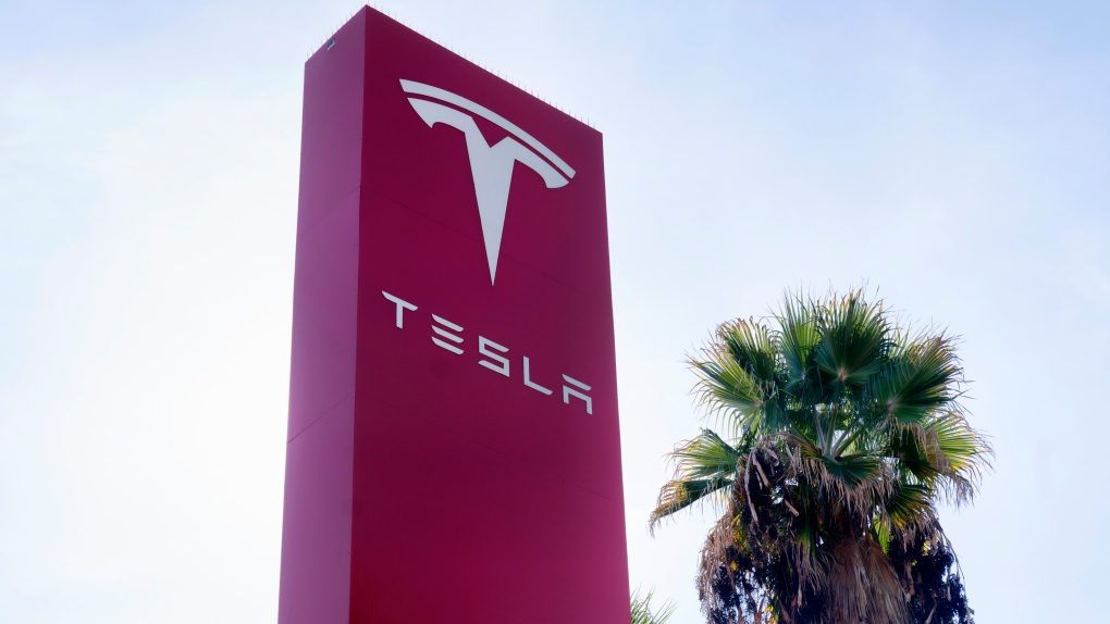 A Tesla sign is seen at Tesla in Buena Park, Calif. on Sunday Dec. 3, 2023. (AP Photo/Richard Vogel)