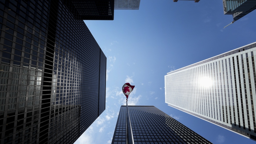 The Bay Street Financial District is shown with the Canadian flag in Toronto on Friday, August 5, 2022. CANADIAN PRESS/Nathan Denette