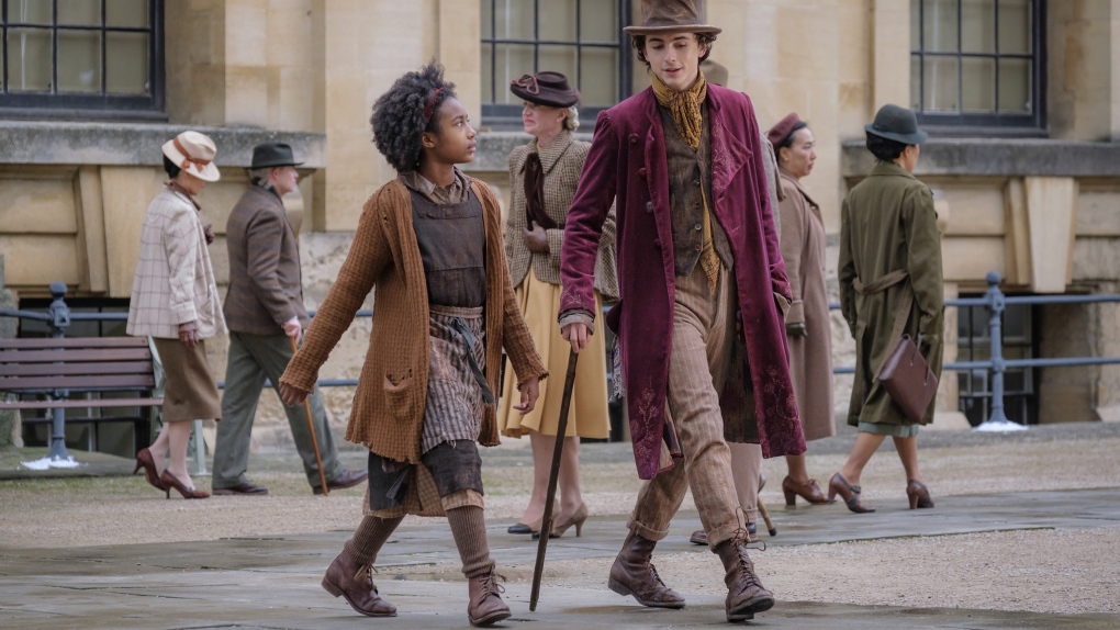 This image released by Warner Bros. Pictures shows Calah Lane, left, and Timothee Chalamet in a scene from "Wonka." (Warner Bros. Pictures via AP)